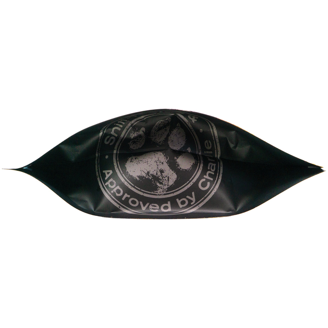 Bottom view of Chompin’ Charlie Bacon Cheeseburger Flavor dog treats bag featuring paw print logo and 'Approved by Charlie' seal.