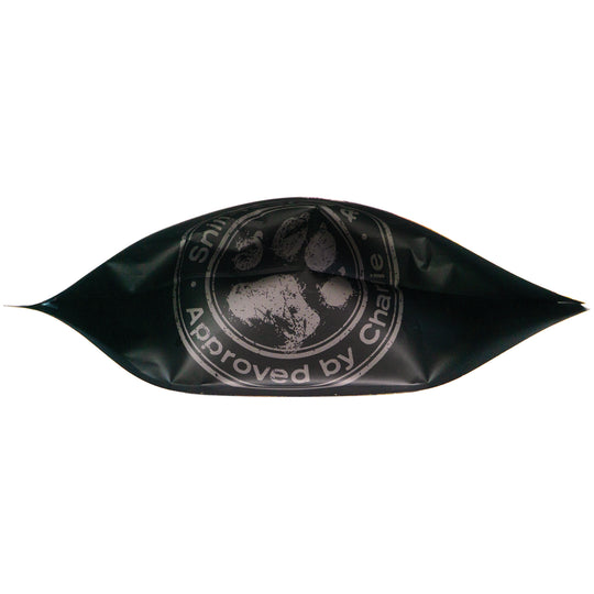 Bottom view of Chompin’ Charlie Bacon Cheeseburger Flavor dog treats bag featuring paw print logo and 'Approved by Charlie' seal.